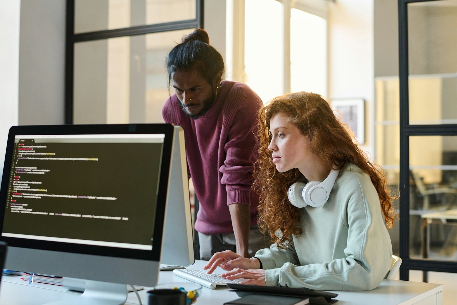 Colleagues typing computer codes together