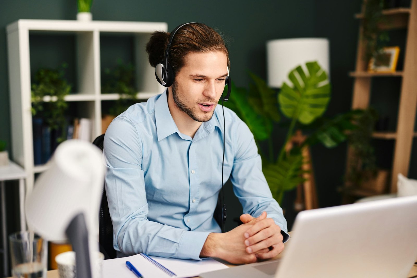 Young man working as customer support in the office